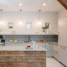 Cottage Kitchen With Wooden Island and Shiplapped Walls