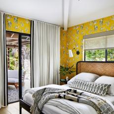 Bedroom With Yellow Wallpaper and Patio Access