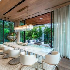 Formal, Contemporary Dining Room With Glass Chandelier