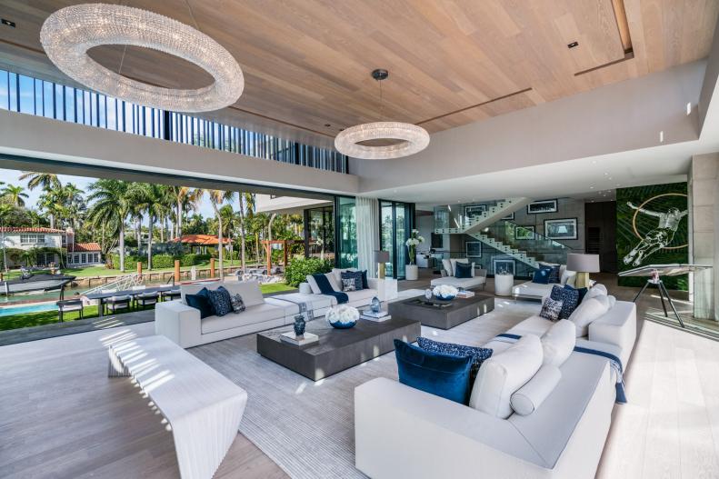 Spacious Indoor/Outdoor Living Room With Circular Chandeliers