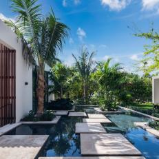 Contemporary Patio With Custom Pond and Palm Trees