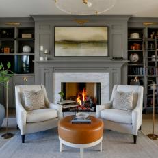 Gray Transitional Sitting Area With Brown Ottoman