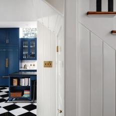 Reimagined Kitchen With Navy Blue Cabinets and Checkered Floor