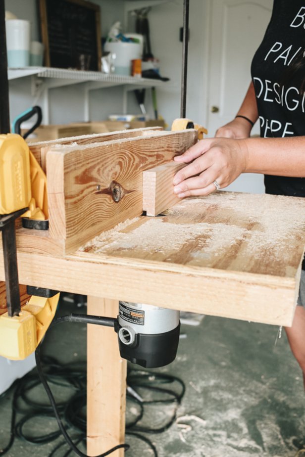 Liz Rishel from Within the Grove uses a router to route a ledge along the top, backside of each piece of pine board.