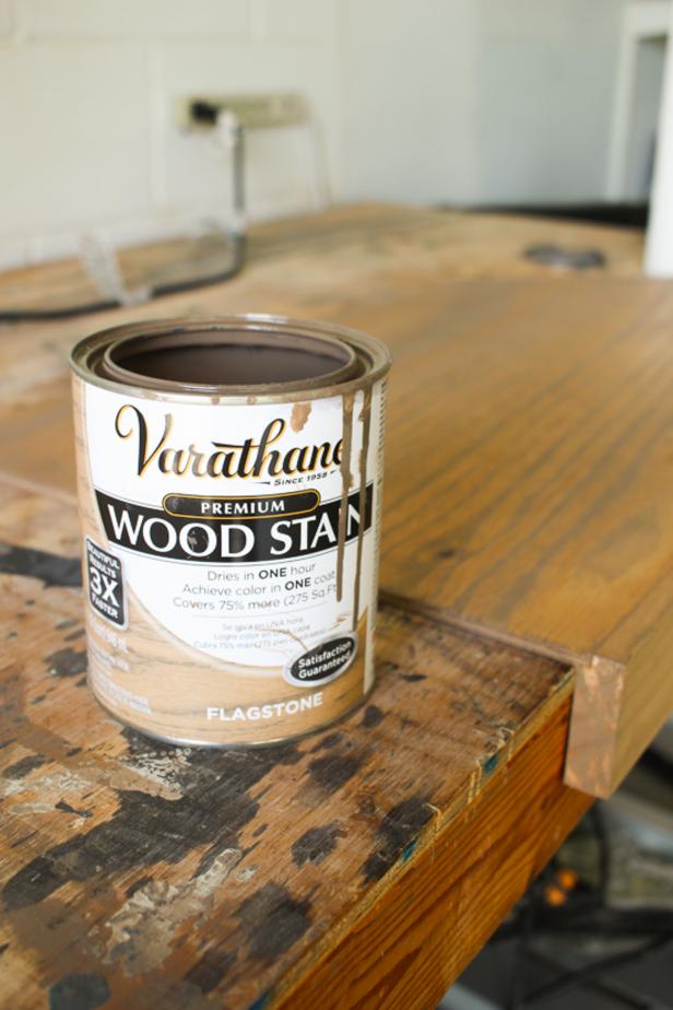 Can of wood stain next to the wood shelf