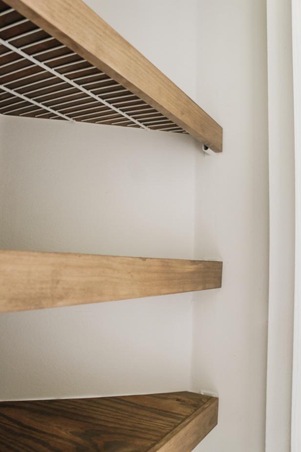 Liz Rishel from Within the Grove creates wood shelf covers for wire shelves in a closet.