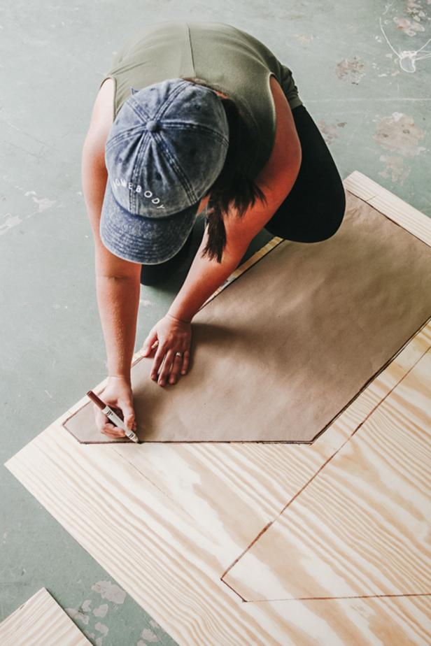 Woman tracing the shelf shape onto plywood