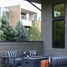 Patio With Black Outdoor Furniture and a Fire Pit