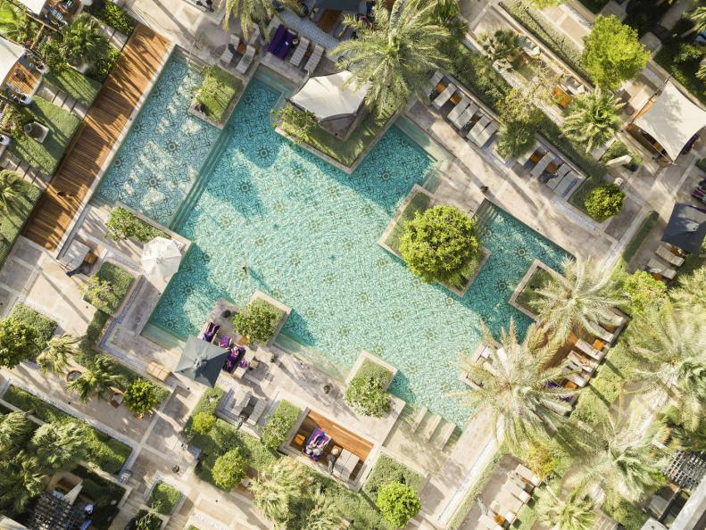 A bird's-eye view of the swimming pool surrounded by cabanas at Jumeirah Al Naseem in Dubai.
