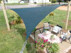 Add instant shade for not a lot of money and just a little bit of elbow grease by hanging a triangular shade cover over your patio or deck.