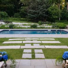Expansive Backyard Features a Pool and Cement Stepping Stones