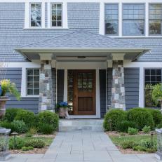 Traditional Home With Stone Accents Features a Paver Walkway Leading to the Front Door