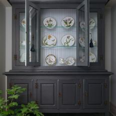 A Large Antique China Cabinet Is Tucked Into a Small Nook 
