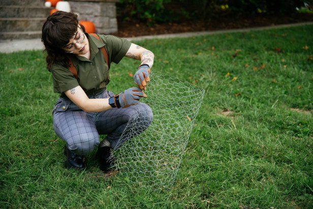 Chicken wire is rolled as part of a DIY Halloween decoration project that will resemble a large ghost.