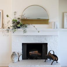 White Stone Fireplace and Arched Mirror