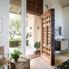 Modern Foyer With Carved Wood Front Door