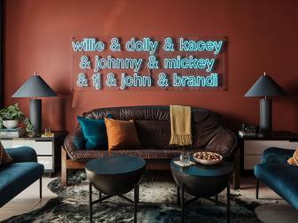 Burnt sienna walls provide a warm, moody backdrop for this modern and relaxing den space. Classic Italian design infuses the vintage 1970’s leather sofa in a low-slung masculine style and offers plenty of room to gather with friends or unwind after a long day.
