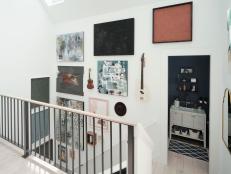 The work of Southern artists and vintage instruments that celebrate the rich musical history of Nashville were used to create the attractive gallery wall along the staircase leading up to the second floor of HGTV Urban Oasis 2022.