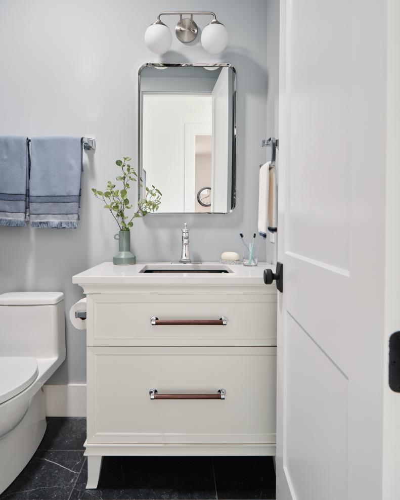 The guest bathroom’s all-drawer vanity features suburb craftsmanship, with an elegant minimalist design that has a mid-century influence.