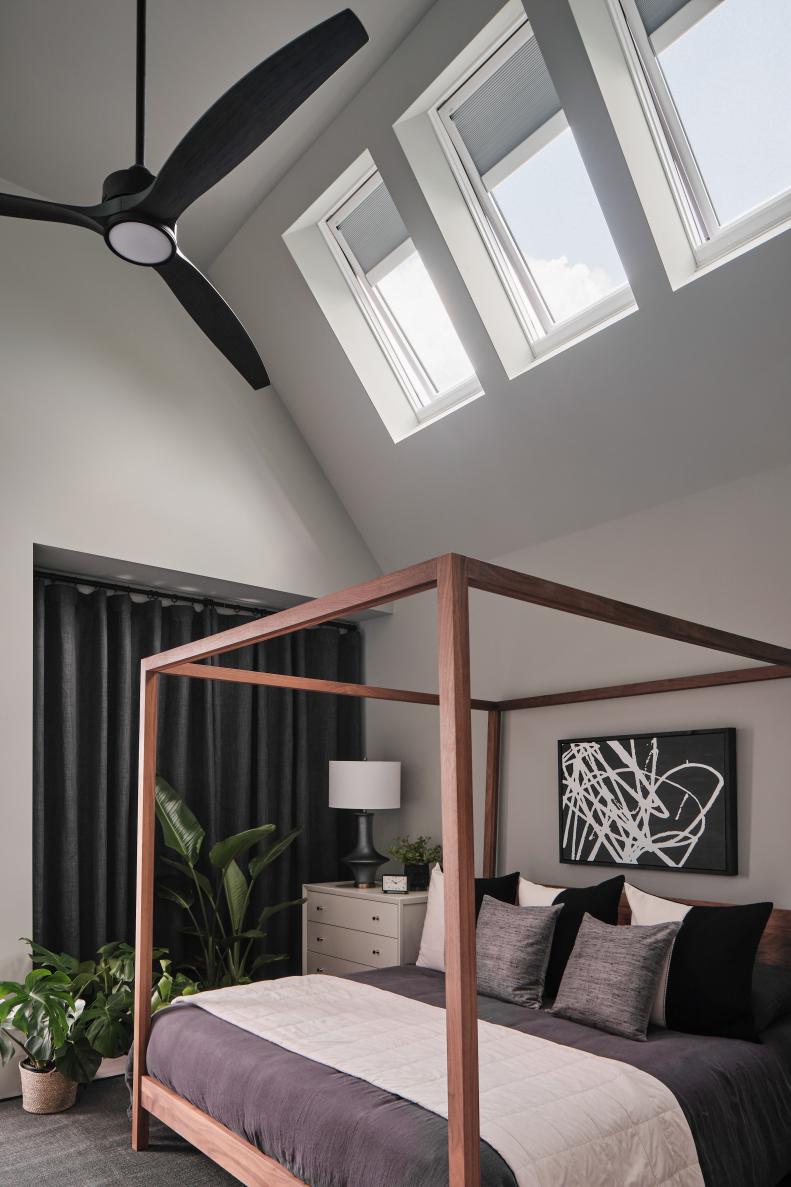 A trio of skylights in the ceiling of the main bedroom fill the space with natural light and draw the eye upward to accentuate the tall ceilings for a spacious and airy feel.