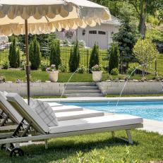 Neutral Umbrellas and Chaises Beside Rectangular Pool 