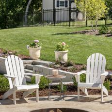 Fire Pit With White Adirondack Chairs and Occasional Table 