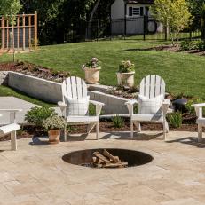 In-Ground Circular Fire Pit With White Adirondack Chairs 