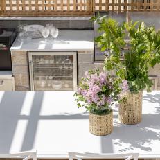 Outdoor Kitchen With Greenery in Wicker Vases 