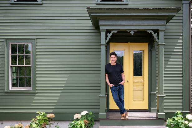 Jonathan Knight on the front porch of the newly renovated Knight farmhouse, as seen on Farmhouse Fixer.