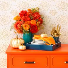 Orange Buffet Table Styled With Pumpkins and Flowers