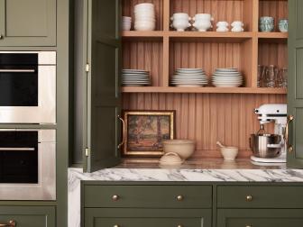 Green Kitchen Cabinets With Folding Doors and Marble Countertops 