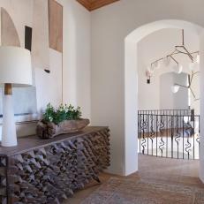 Contemporary Mediterranean Hall With Architectural Sideboard and Arched Door 