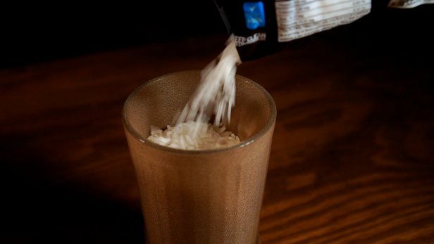 Slide a nylon stocking over a pint glass and pour dried rice into the glass. Carefully remove the rice-filled stocking and tie a knot to form a small ball.