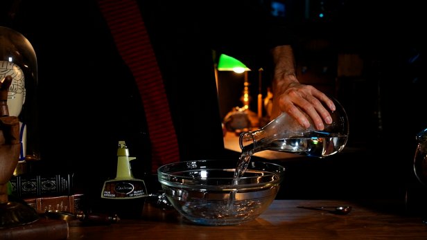 First add 2-1/2 cups of room temperature water to a mixing bowl. Turn on the electric mixer and slowly add in 1 teaspoon of sodium alginate powder to the bowl. Tip: The alginate powder will clump up, so keep mixing and increasing the speed until the mixture is dissolved and a thick, viscus liquid is produced. Next, add red food coloring to make organ-like specimens. Stir the mixture together with a wooden spoon. In a glass cup, add 2-1/2 cups of cold water and 2 tablespoons of calcium chloride and mix with a wooden spoon until dissolved. Tip: The longer you let the mixture sit after its dissolved, the clearer the water will become.