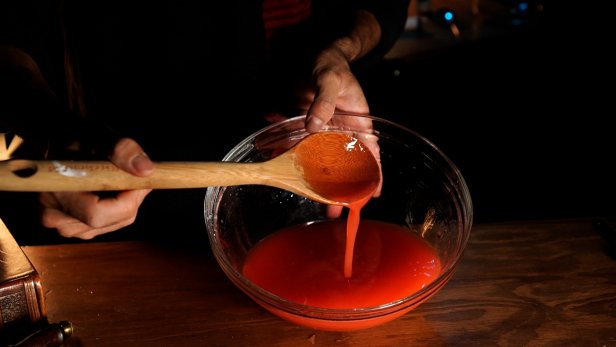 First add 2-1/2 cups of room temperature water to a mixing bowl. Turn on the electric mixer and slowly add in 1 teaspoon of sodium alginate powder to the bowl. Tip: The alginate powder will clump up, so keep mixing and increasing the speed until the mixture is dissolved and a thick, viscus liquid is produced. Next, add red food coloring to make organ-like specimens. Stir the mixture together with a wooden spoon.