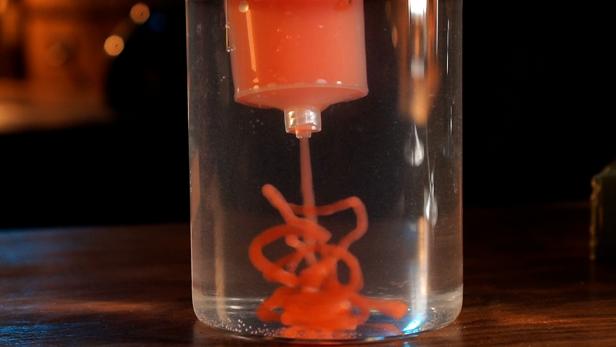 Use a plastic syringe to extract the red dyed sodium alginate mixer. Then add it to the calcium chloride mixture. The syringe will create worm-like, long strings that appear as organs. Once all the faux creations are made, remove them from the calcium solution with your hands. Place the DIY organs into apothecary jars filled with water, then add a few drops of food coloring for add contrast. Add fake eyes, ears and fingers to the jars for a creepier-looking concoction and enjoy.