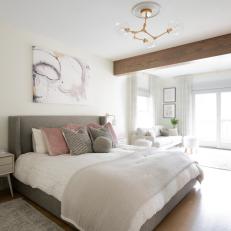 Neutral Transitional Primary Bedroom With Beam
