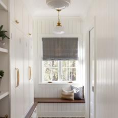 White Country Mudroom With Brick Floor
