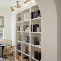 White Bookshelves and Brass Lights