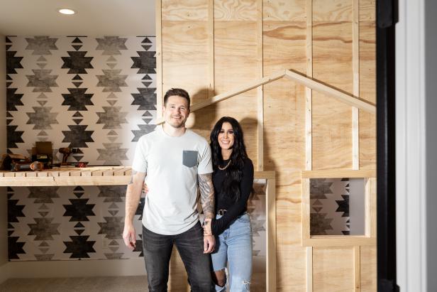 As seen on HGTV’s Farmhouse Fabulous, a portrait of Chelsea and Cole DeBoer near their halfway-finished children’s new playhouse in the basement.