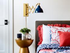 Blue and Red Bedroom With Brass Details
