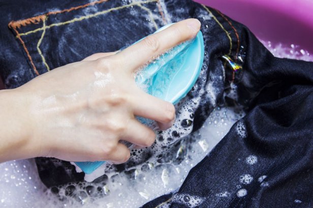 Woman is washing blue jean