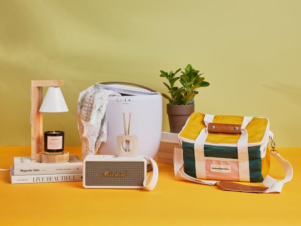 A styled photo with gift ideas for Mom including a Bluetooth speaker, towel warmer and cooler bag