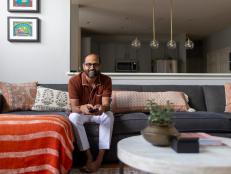 Designer Mitesh Trambadia Seated on a Couch With Colorful Cushions