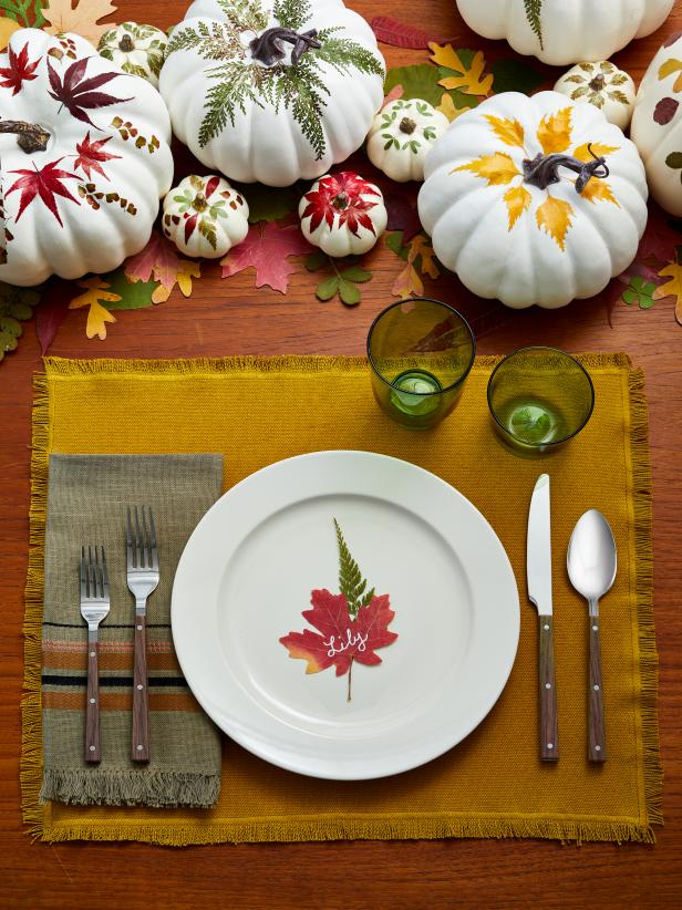 Thanksgiving Table With White Pumpkins and Pressed Leaves