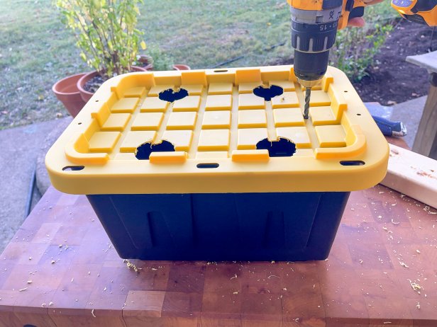 The next step in this DIY hydroponic garden is to drill a hole in the plastic lid for the air hose to fit through.
