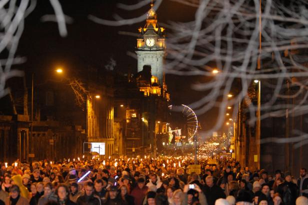 A crowd gathered to celebrate New Year's Eve beneath Edinburgh Castle in Scotland .