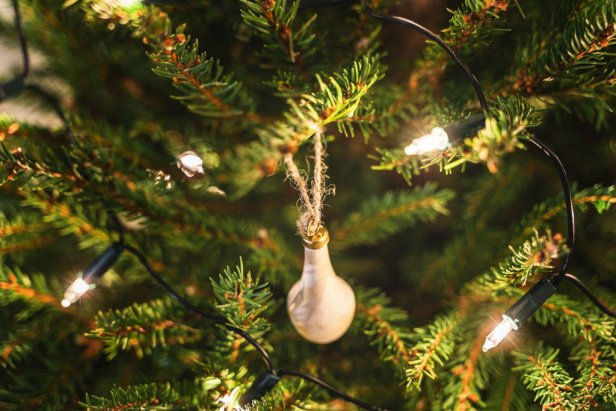 Close-up background of christmas tree with decorations and fairy lights