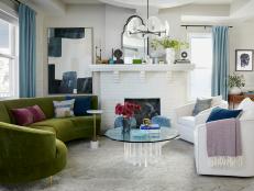 White Family Room With a Green Sofa and Blue Curtains