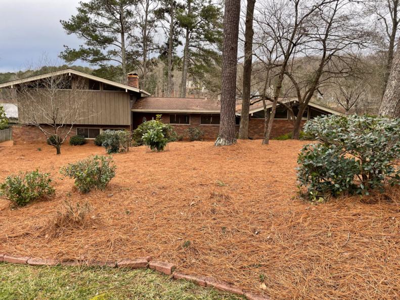 Brick and brown 1970s split-level house with large yard 